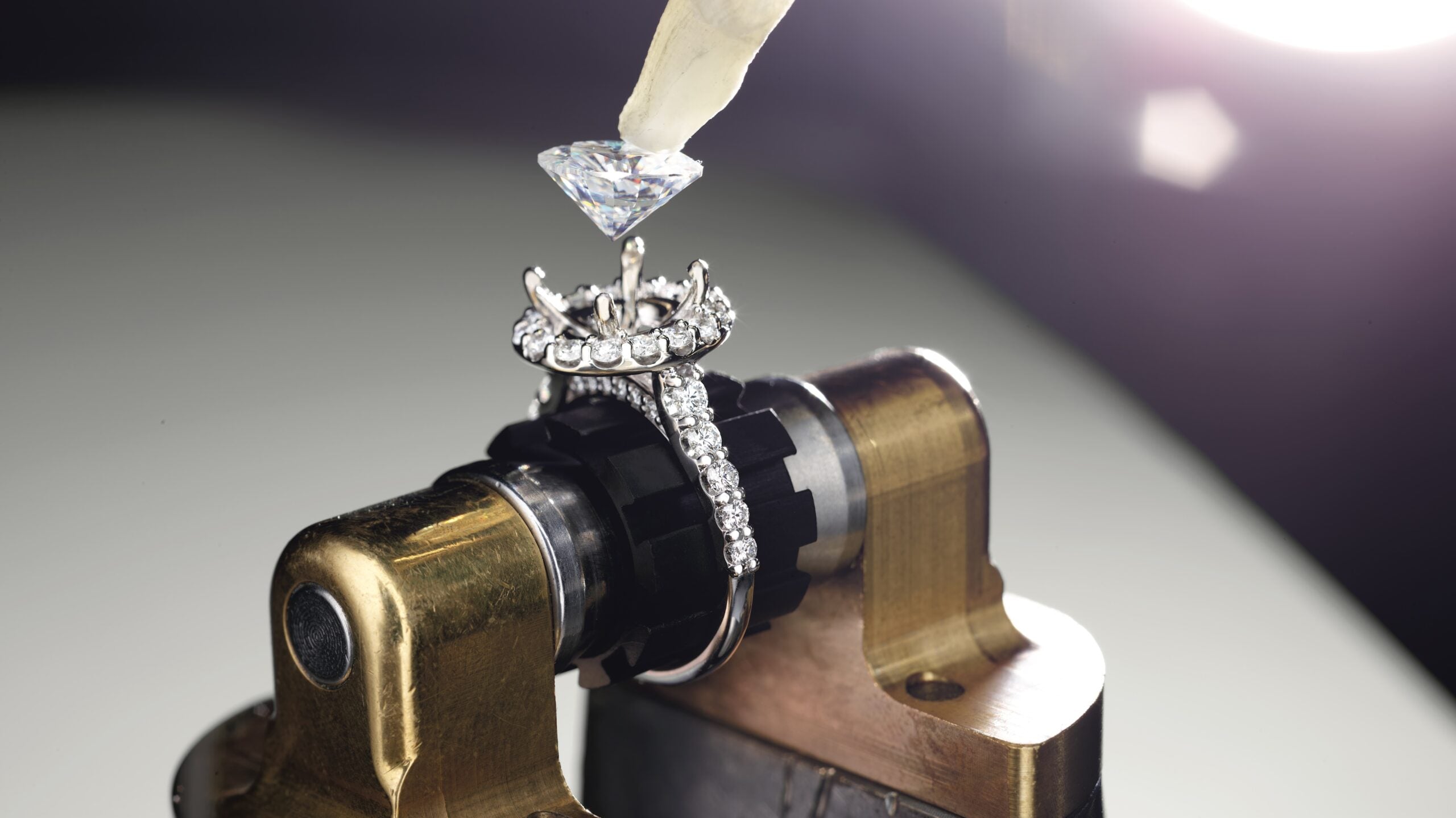 Diamond being set in an engagement ring setting