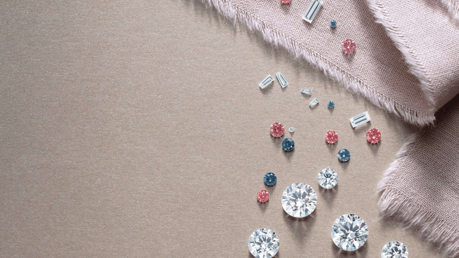 Natural and Lab-grown diamonds in various sizes, cuts and colors on a beige surface