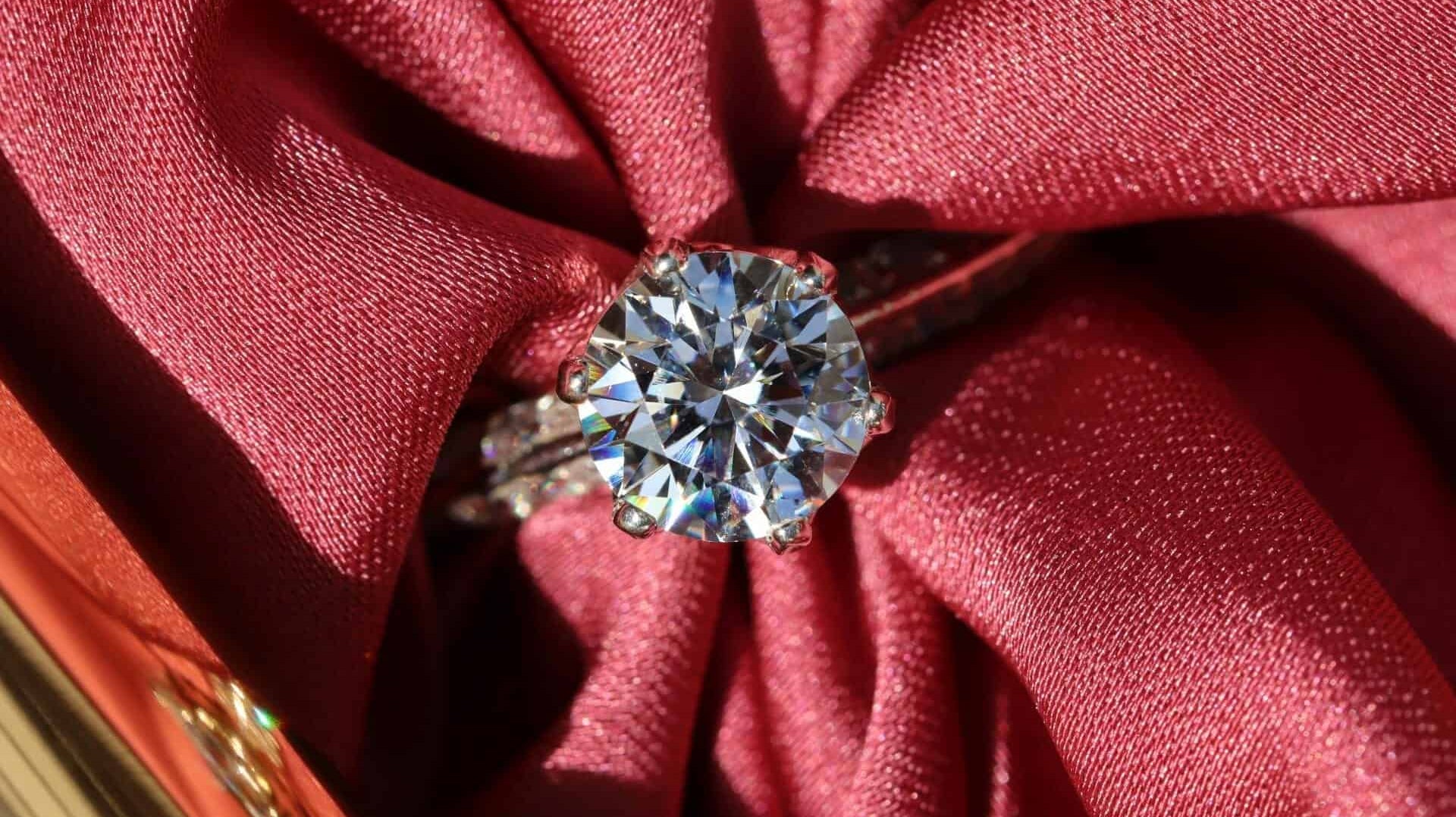 A beautiful conflict-free diamond ring wrapped in a red cloth.