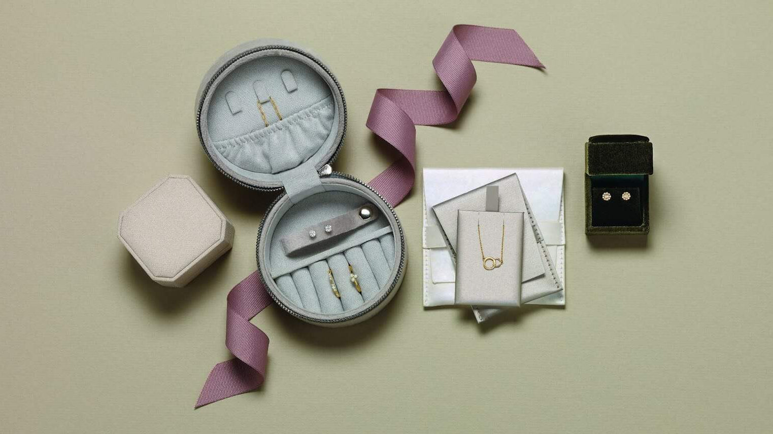 Several pieces of jewellery organised into a carrying case made for travelling with jewellery.