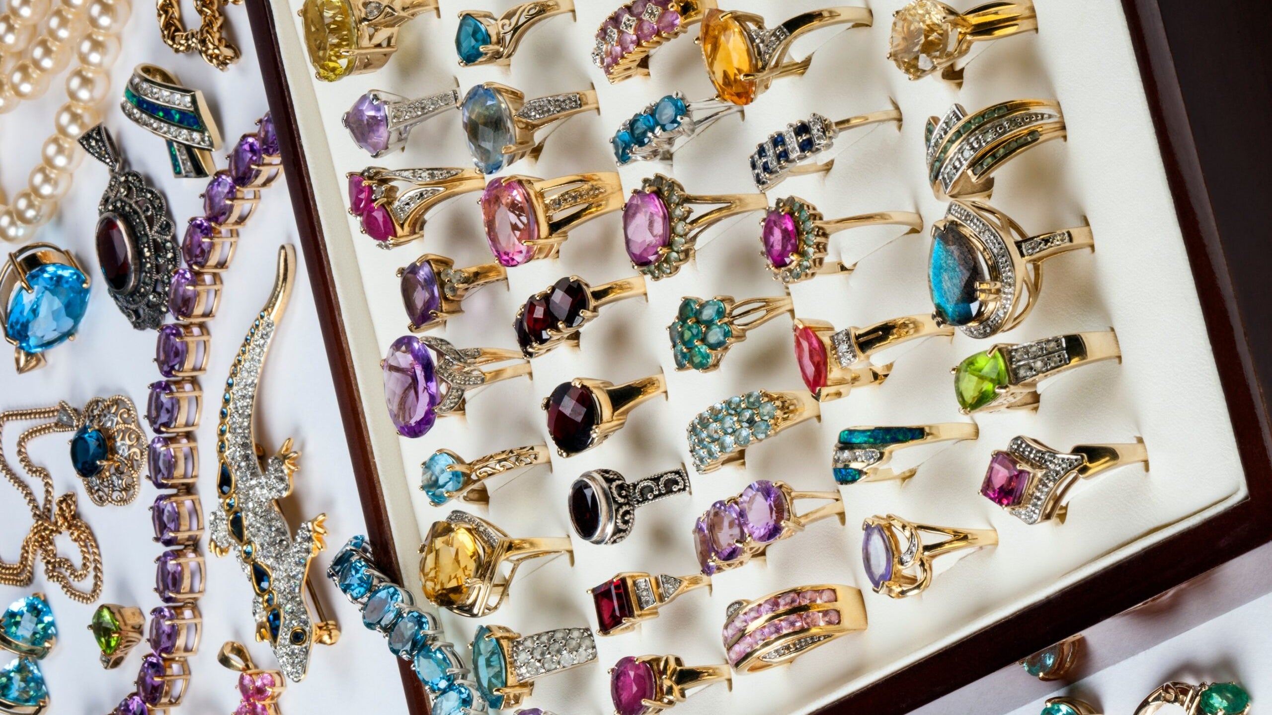 A collection of rings and other jewelry including diamonds, ruby, emeralds, garnets, amthyst etc.