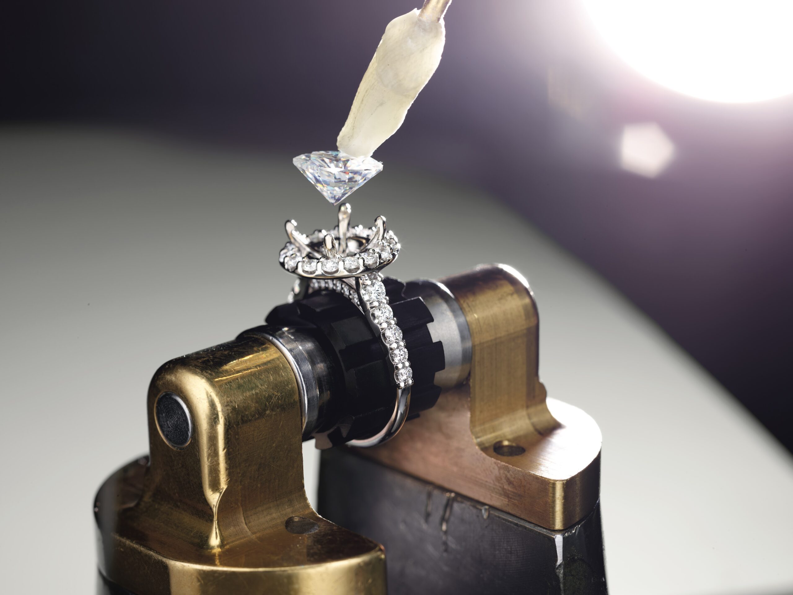 Diamond being set in an engagement ring setting