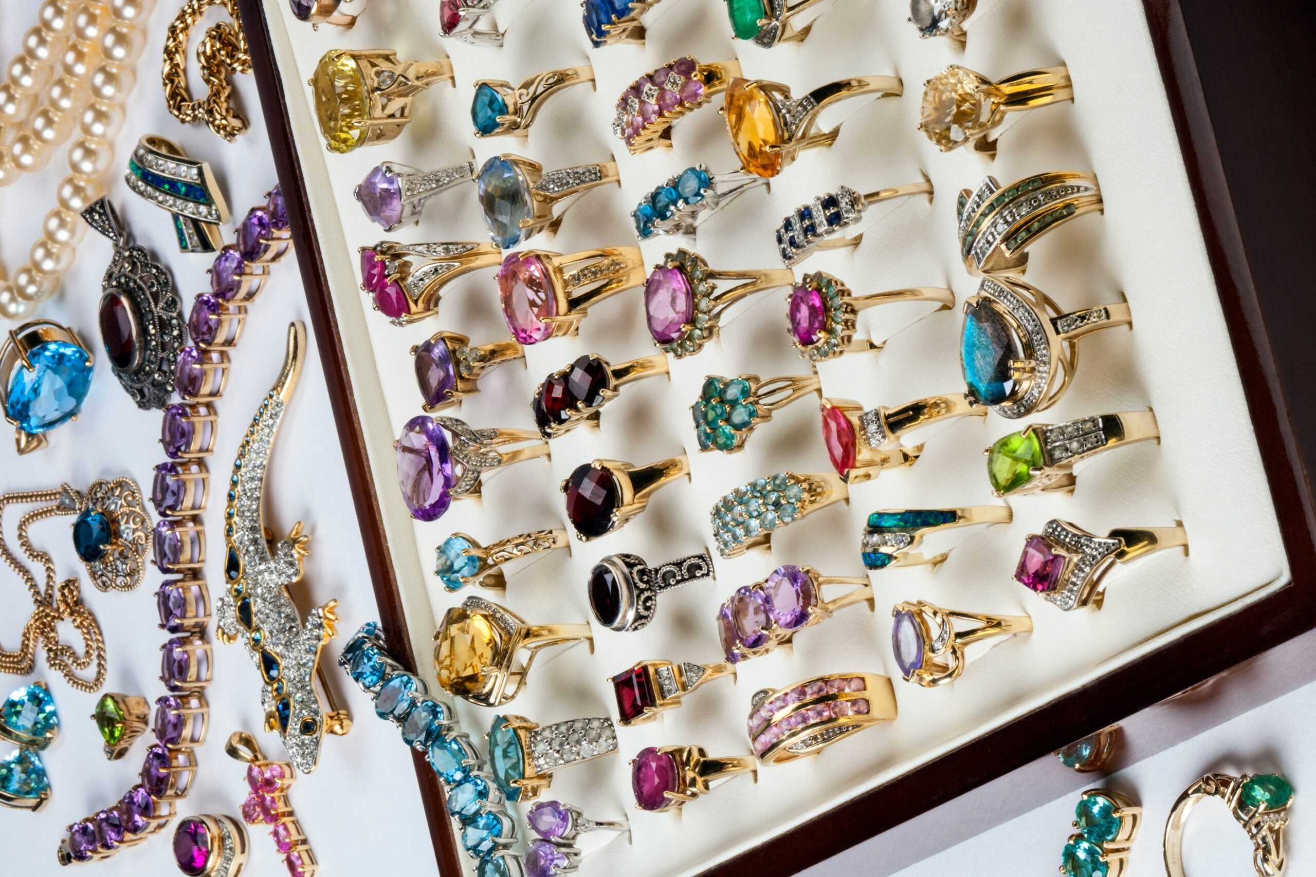 A collection of rings and other jewelry including diamonds, ruby, emeralds, garnets, amthyst etc.